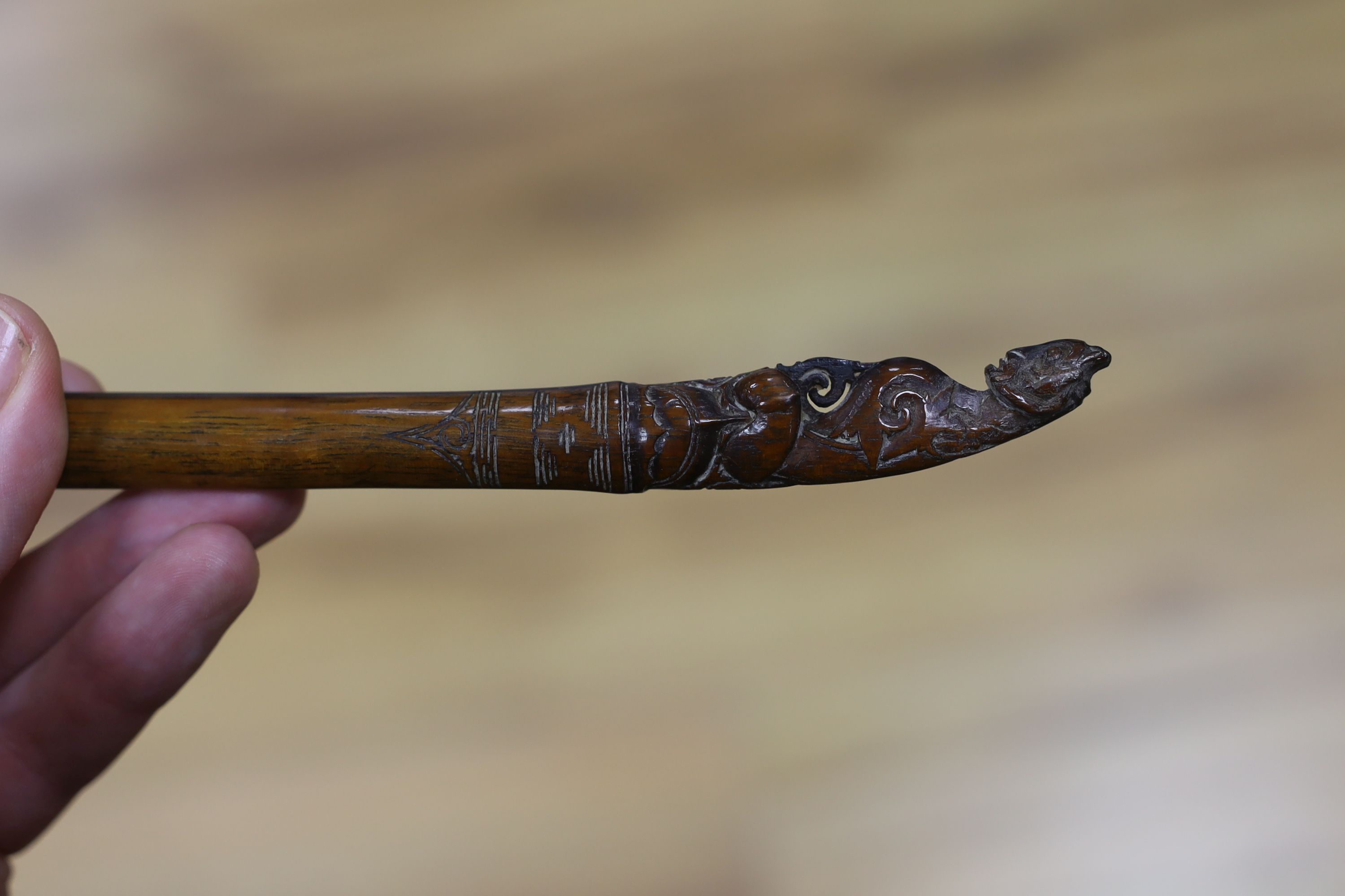 A Borneo 'headhunter's sword', a bone carving and feather swot (3), sword 77 cm long